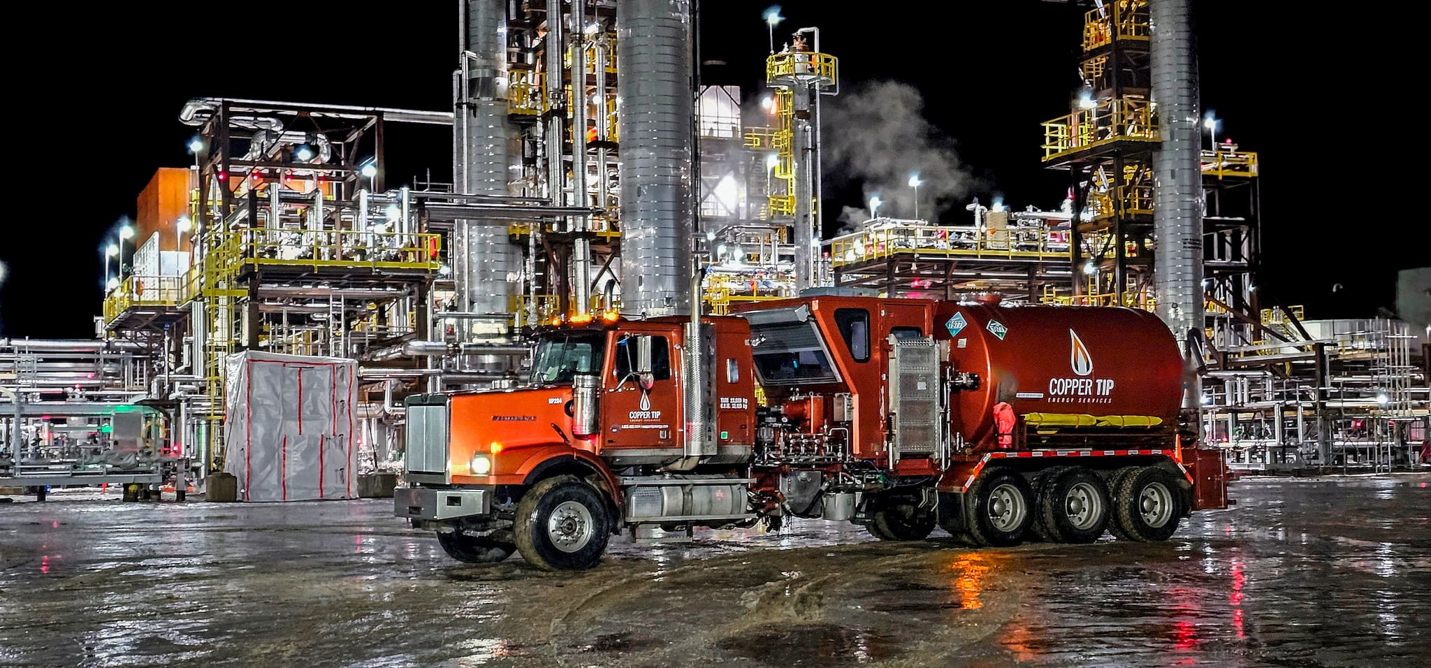 Copper Tip Energy Services fluid pumping unit deployed at a night industrial plant