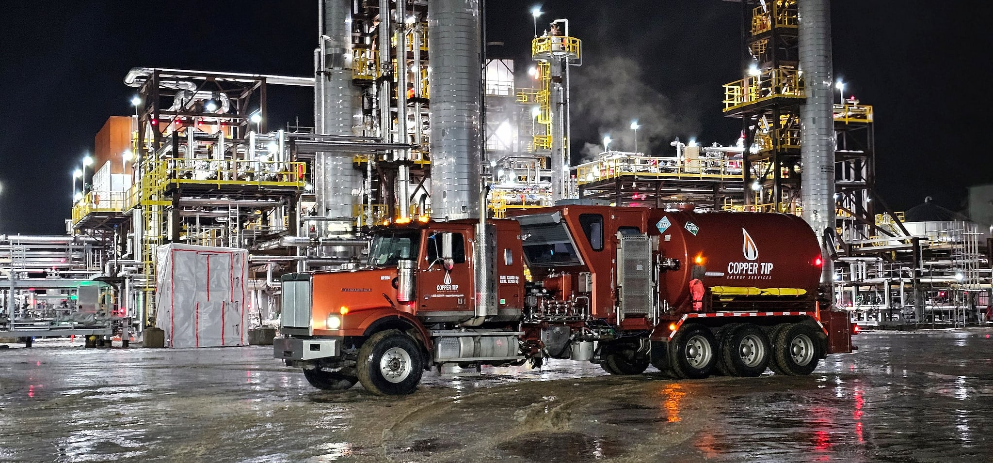 Copper Tip Energy Services fluid pumping unit deployed at a night industrial plant
